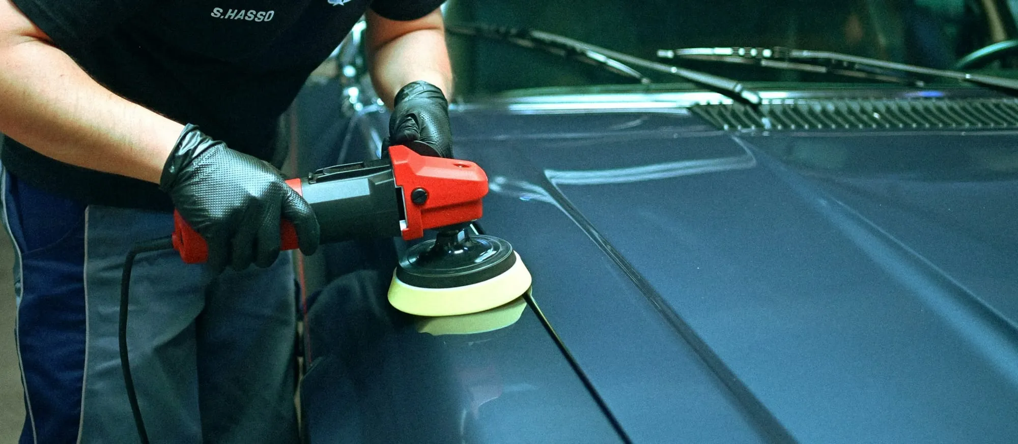 Machine polishing a blue hood