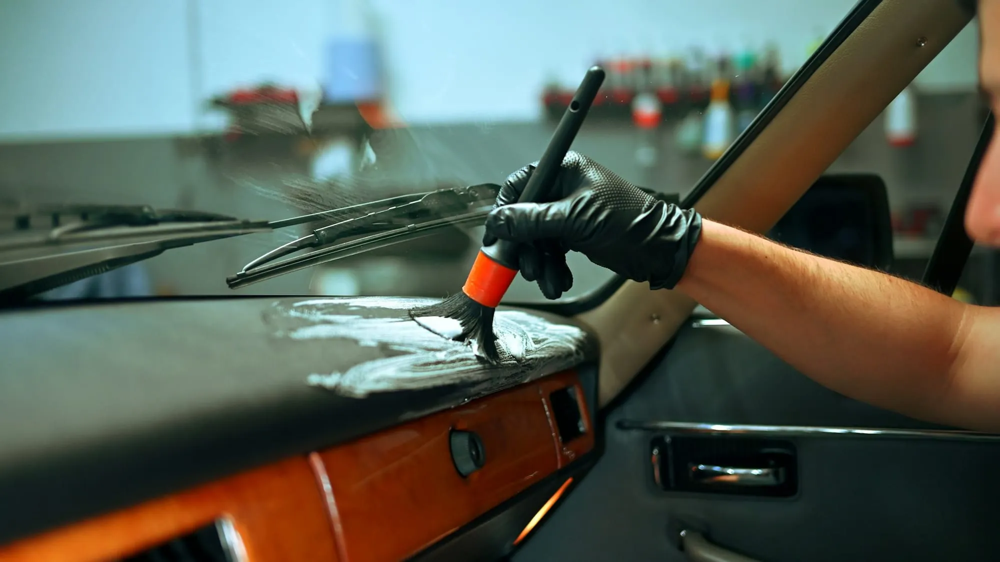 Detail brush cleaning a wooden dashboard