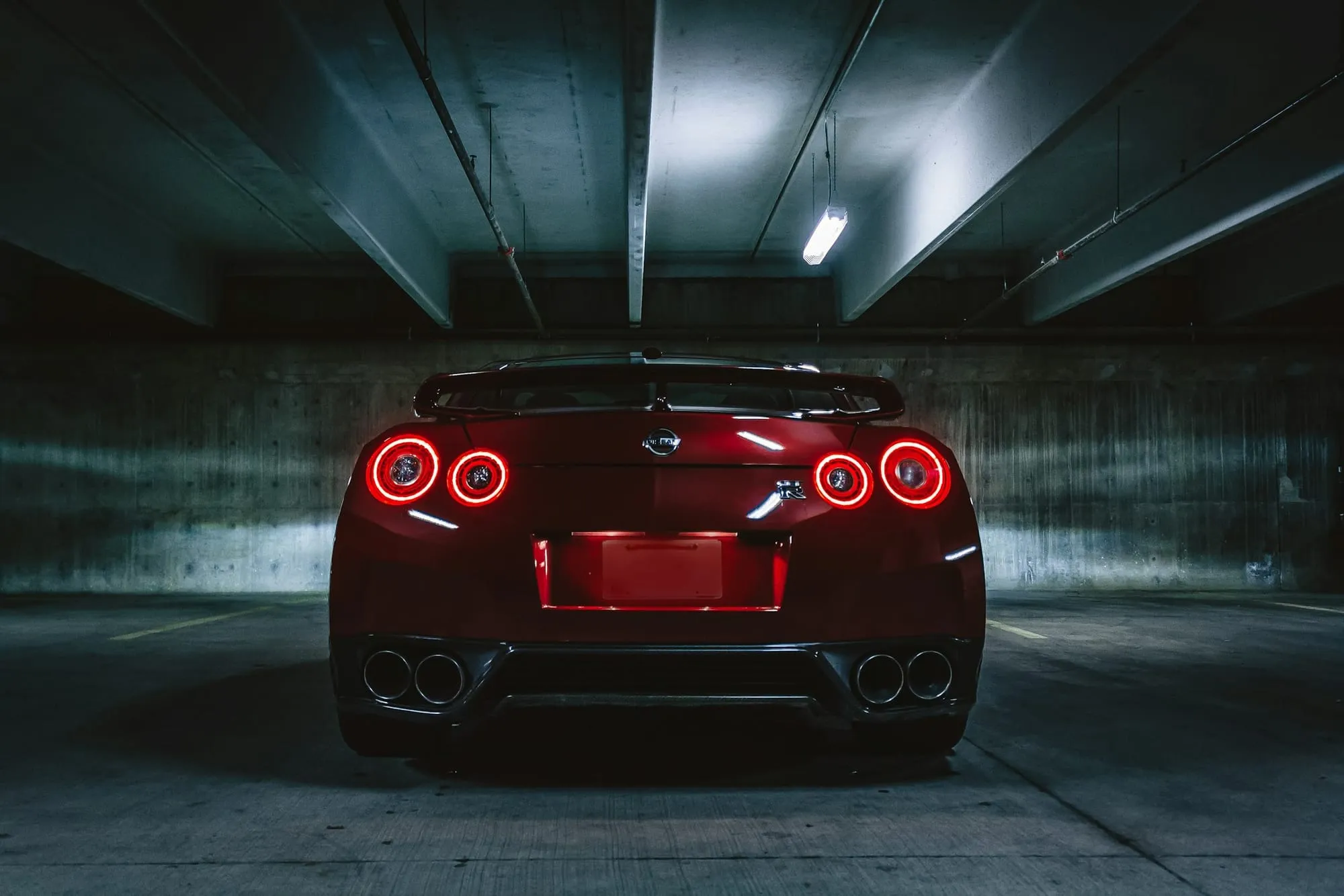 Dark red sports car in an underground garage