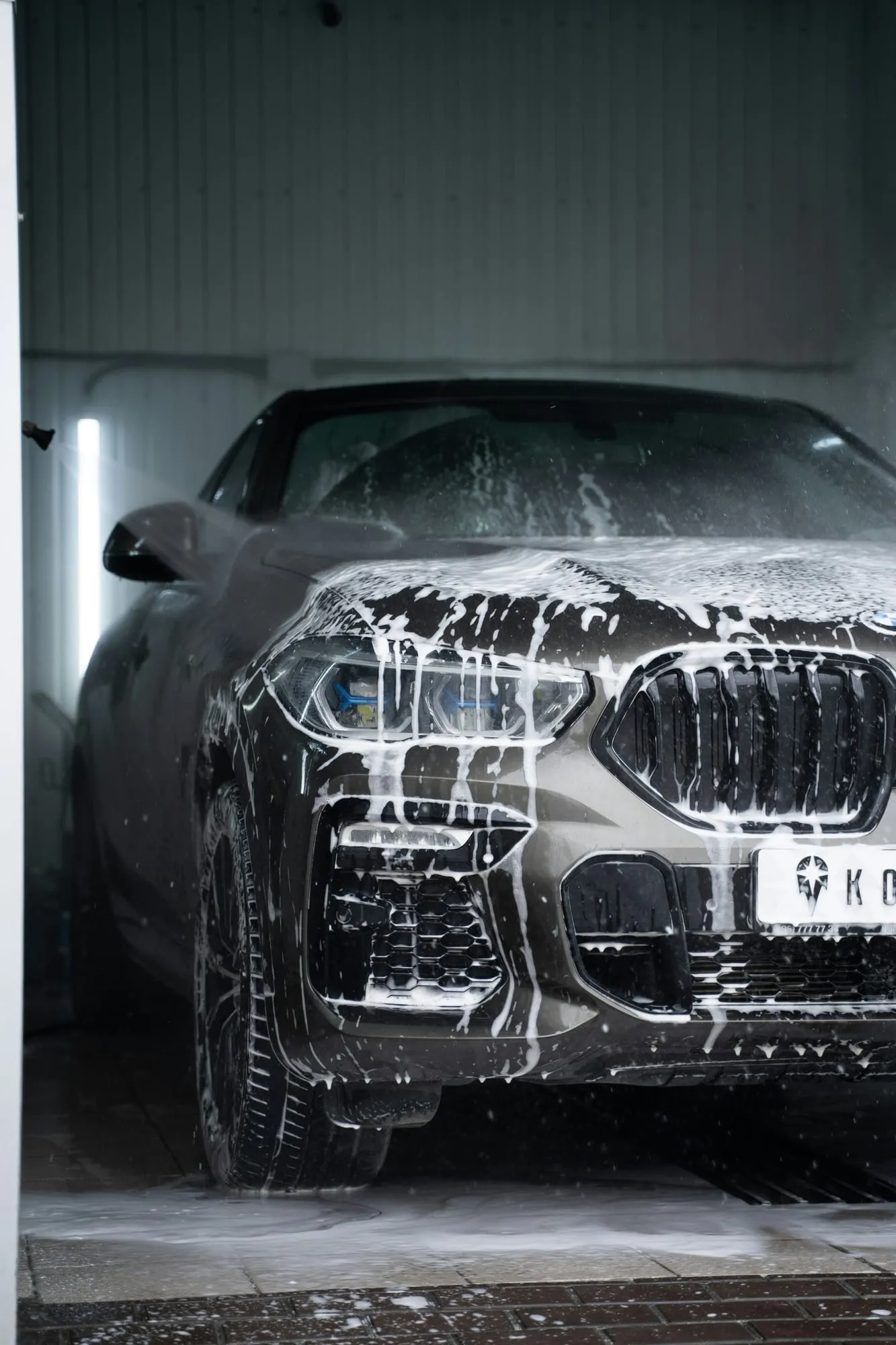 Grey SUV covered in snow foam